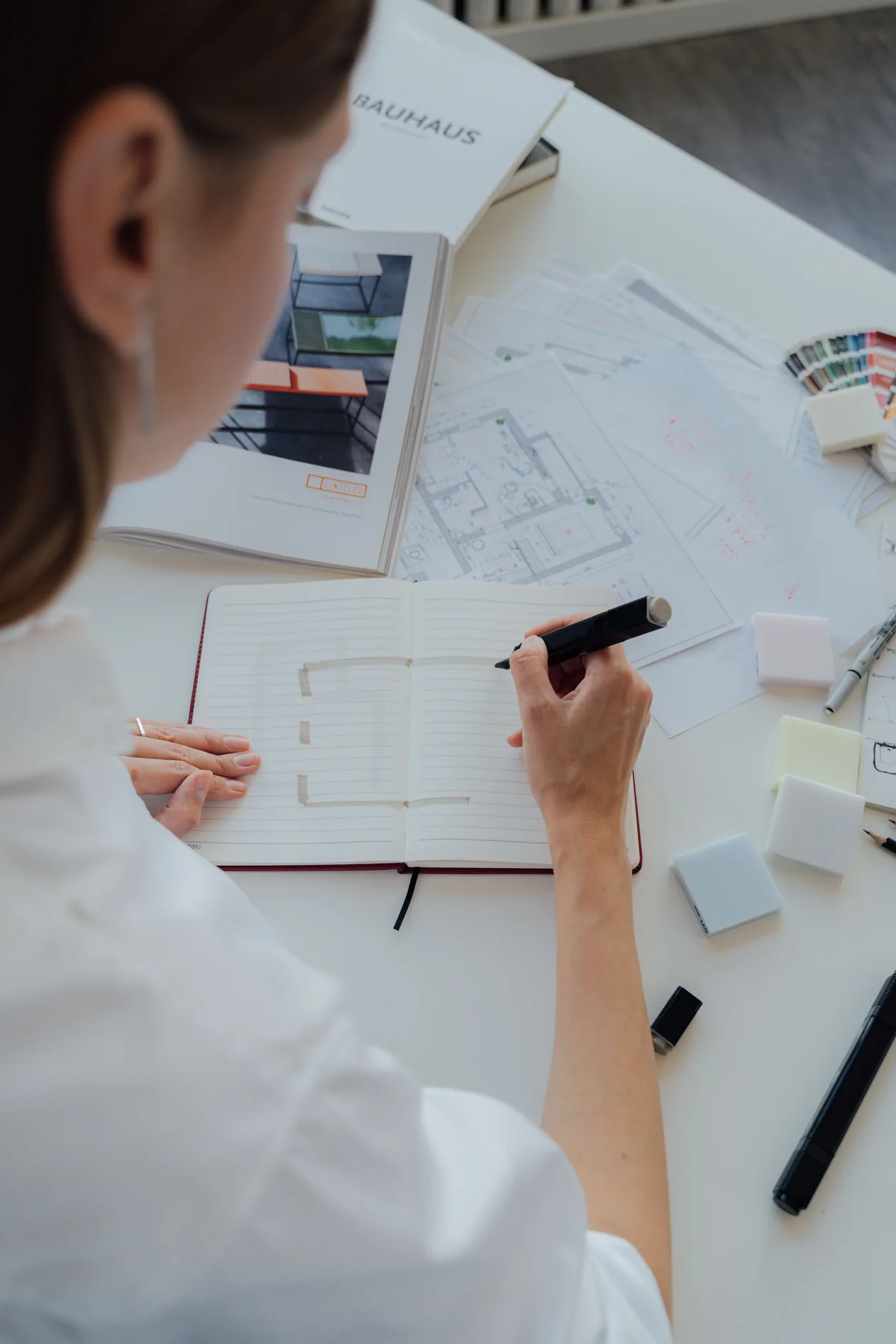 Architect working on floor plans at a desk